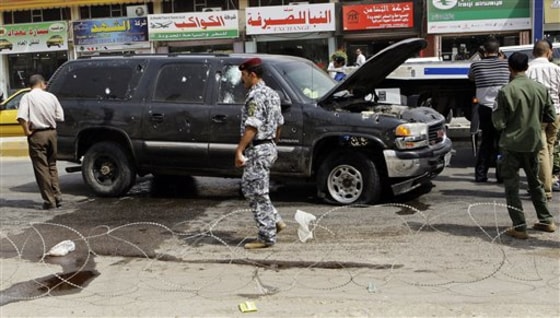 Iraqi security forces inspect the scene of a roadside bomb in central Baghdad, Iraq, on Sunday. The blast killed a passer-by and wounded several others in the mixed Sunni-Shiite Karradah neighborhood. Officials said the bomb appeared to be targeting a police patrol.